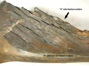 View of the interior surface of the cylinder along the rupture on side “A” exhibits numerous longitudinal cracks. The ID cracks opened during the rupture event. All of the cracks are within approximately 18 inches (46 cm) of the cylinder bottom. 
