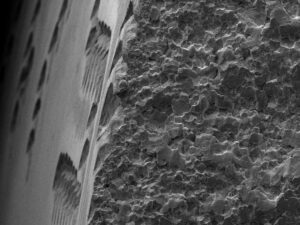 An increased magnification SEM view shows there is intergranular fracture, which is indicative of a high hardness, brittle condition at the fracture origin.