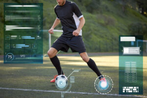 sport, technology and people concept - soccer player playing with ball on football field