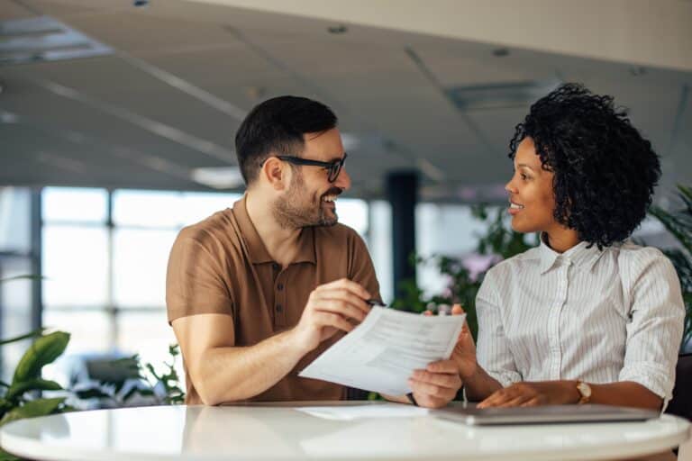 Expert Human Factors Consulting two people working at a table talking to each other