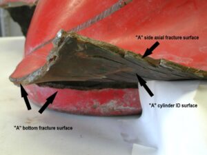 A close up photo of fracture side “A” near the cylinder bottom. The axial fracture surface displays multiple jogs resembling a stair-step appearance. The interior (ID) surface exhibits numerous cracks. These features are shown in closer views in subsequent figures. 