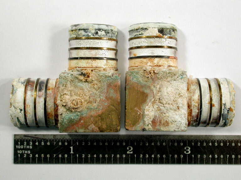 The above image shows the two brass elbow plumbing fittings in the received condition for analysis. Significant deposits and various stains were observed on the outer surface of the fittings.