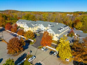 Historic residential house aerial view in fall at Concord Park in West Concord, town of Concord, Massachusetts MA, USA.
